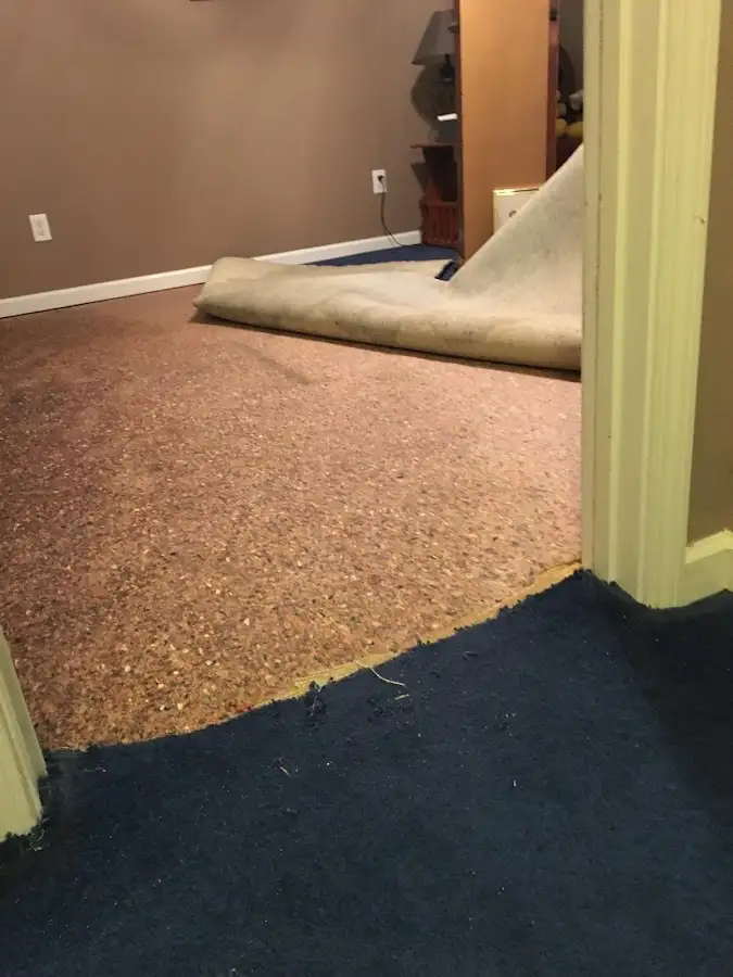 Carpet pad removal revealing water damage during Drying & Dehumidification in Meadow Lakes